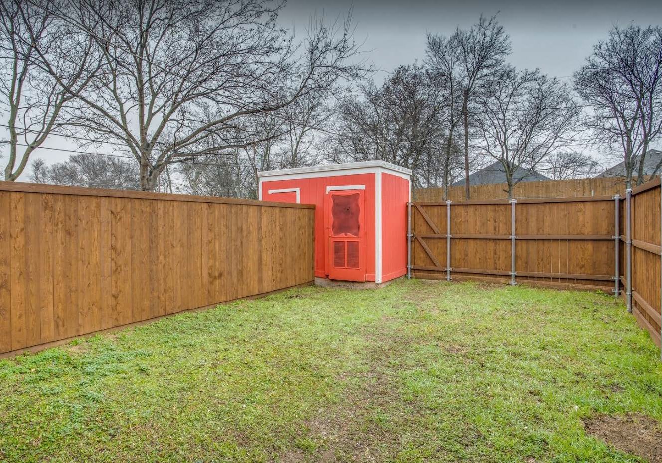 Private fenced backyard with storage shed